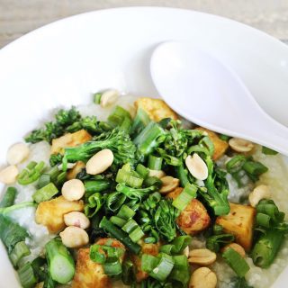 gluten-free and vegan congee with broccoli, scallions, tofu and peanuts