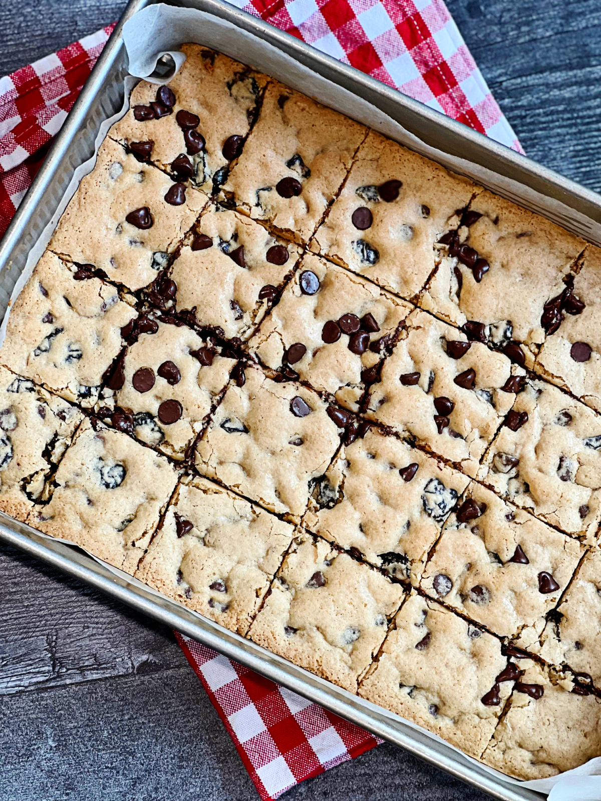 This is a new recipe for chocolate chip cookie bars, and they are so so, so good! I created them for our latest Everyday Dish video, and loosely based it off of a couple other chocolate chip cookie recipes of mine. They are really easy to make and you simply press the dough into a 9 x 13-inch pan. I will be sharing more flavor variations of this recipe too.  Disclosure: This post contains affiliate links. As an Amazon Associate, I earn from qualifying purchases. Before I get to the cookies though, I really want to share a bit about the amazing Ankarsrum mixer. It's from Sweden and has been around since the 1940's. What I really love though is the power and engineering of the machine. It's unlike the stand mixers that we're all so accustomed too. First off is the engineering. It kneads smooth and silky doughs, due to its roller and scraper design. This method mimics kneading by hand, without the time and effort. It has a 7 1/2 quart stainless bowl that revolves as the mixer runs, and the fluted roller acts as your fingers, with the scraper mimicking the palm of your hand. The scraper folds the dough with a rhythmic motion while the roller turns. Not only does this perform magic with bread doughs (and yes, even gluten-free doughs!), but it's magic with cookie and other doughs too. It also comes with a special bowl and whisks for making fluffy meringues and whipped toppings (I'm looking at you aquafaba and whipped coconut cream!). Needless to say that I am head-over-heels for my Ankarsrum mixer (which I have named Astrid thanks to my friends Matthew and Per in Sweden). She's also a looker, thanks to the gorgeous retro colors and design, but like they say "the proof is in the pudding."  Astrid continues to blow me away every time I bake. You can check out the Ankarsrum mixers here on Amazon and also on the Ankarsrum website here. To make the bars I use my favorite gluten-free flour blend recipe here on the site. I make sure to use the half amount of xanthan gum in the flour blend, which I suggest in the recipe for cookies and cakes. I also use a little melted virgin coconut oil, oat milk (or soy or almond), a really good vanilla (like Nielsen-Massey for a punch of vanilla flavor), baking powder, brown and white sugar, and Maldon sea salt. A couple quick tips before I get to the recipe. The first is that I've made the cookie bars a number of times since filming the video, and you want to make sure that the dough is thick like a cookie batter, but still soft enough to spread in the pan. I found that if you mix the milk into the oil and sugar mixture, the batter comes out a little less thick and softer. This resulted in soft and slightly underbaked bars that were incredible (especially once frozen!). I also found that the bars come out a bit crisper when baked in a metal pan and a bit softer when baked in a ceramic one. I haven't tried using a glass pan. Do with that info as you like, but if you like softer and slightly underbaked cookies than use a ceramic 9 x 13-inch baking dish/pan. I think mine is a Le Creuset pan, which I've had forever. I know you're going to want to make these cookies stat! Let me know what you think, and what flavors you'd like me to make next. xoxo Julie